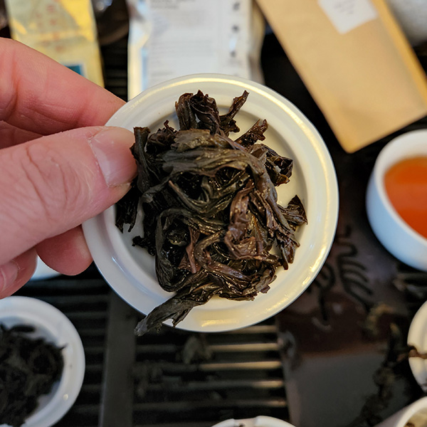 white porcelain lid and a mound of wet tea leaves